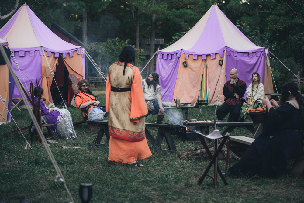 Larp couple seated with mugs